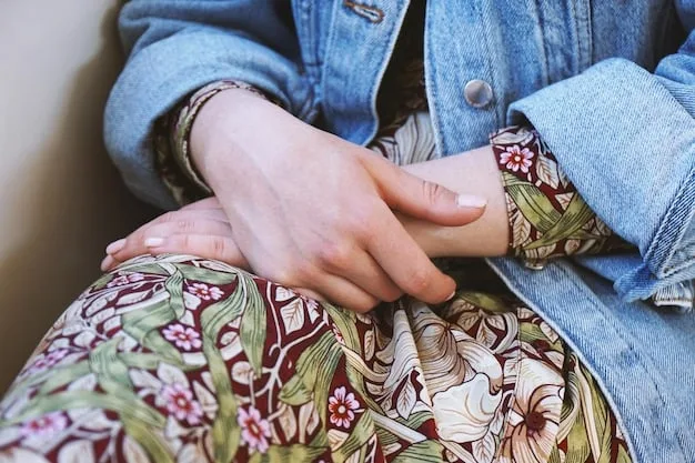 A close-up shot of two fabrics being held together, one with a small floral print in shades of blue and white, and the other with narrow stripes in the same blue and white. The similar color palette creates a cohesive look.