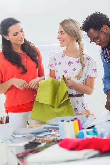 A photograph of a diverse group of consumers shopping for clothes from the new designer collaboration. The image captures the excitement and enthusiasm surrounding the collection, with shoppers trying on clothes, browsing the displays, and interacting with store staff. The overall atmosphere is inclusive and welcoming, reflecting the collaboration's commitment to diversity and accessibility.