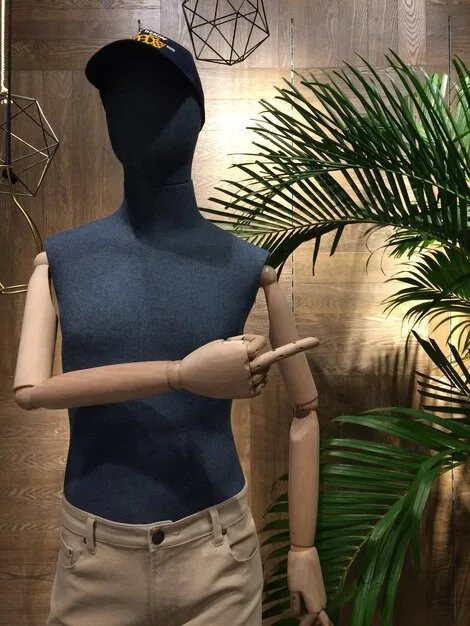 A mannequin wearing a stylish menswear outfit made entirely from recycled materials. The outfit should look fashionable and high-quality, demonstrating the potential of sustainable fabrics.