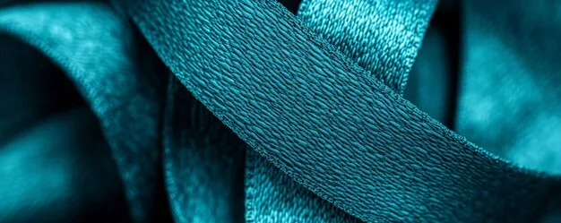 A close-up shot of various fabrics and textures dyed in deep teal, showcasing its depth and versatility.