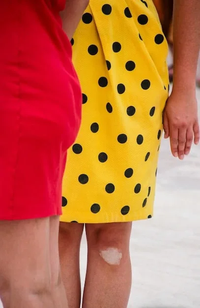 Close-up of two different prints being combined in an outfit: a small polka dot shirt paired with a larger floral print skirt, focusing on the harmonious color scheme and contrast in scale.