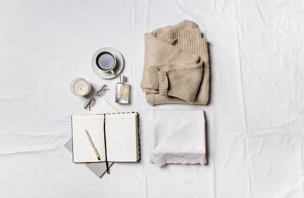 Close-up of 10 essential clothing items laid out on a bed, including a white t-shirt, black trousers, a denim jacket, a neutral-colored sweater, and a classic trench coat. The items are well-organized and visually appealing.