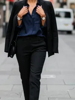 Woman in black blazer and navy blouse, elegant city style