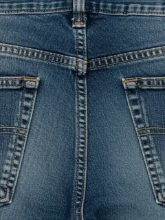 Rear pockets of designer jeans, emphasizing precise placement and stitching details.