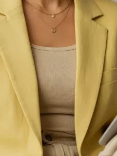 Close-up of a pastel linen blazer and wide-leg trousers