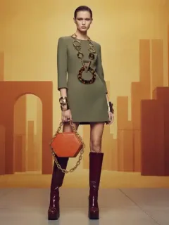 Model wearing bold Fall 2026 accessories including geometric necklace and structured mini-bag