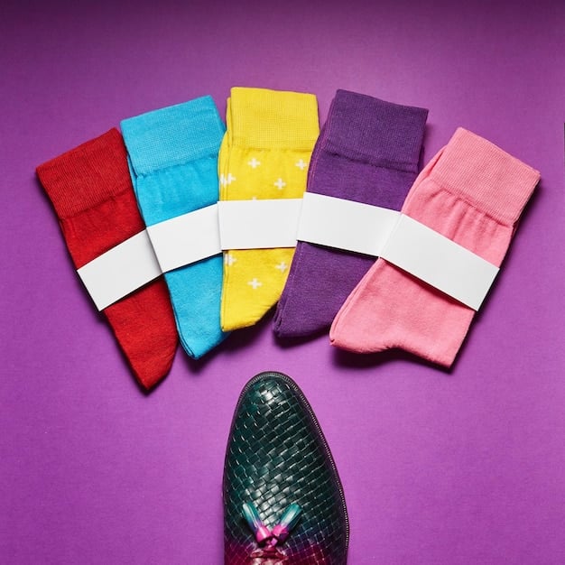 A close-up shot of a rack of pants in the five hottest colors of 2025: vibrant orange, deep teal, pastel lavender, electric blue, and classic grey. The pants are arranged in a visually appealing way, showcasing different textures and fabrics. The background is a blurred clothing boutique.
