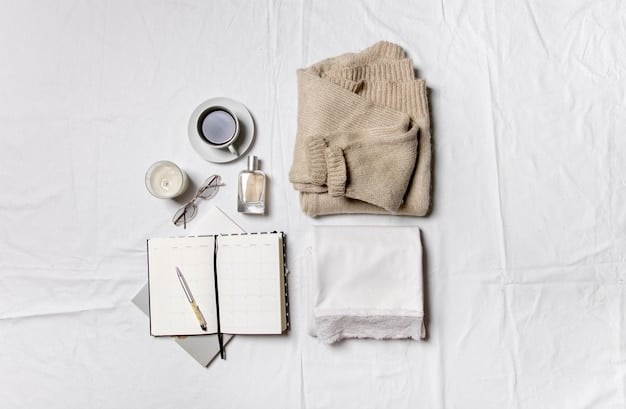 Close-up of 10 essential clothing items laid out on a bed, including a white t-shirt, black trousers, a denim jacket, a neutral-colored sweater, and a classic trench coat. The items are well-organized and visually appealing.