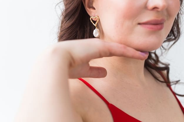 A close-up shot of a woman's hands changing earrings. During the day, she wears simple pearl studs. Now, she is swapping them out for a pair of sparkling chandelier earrings for the evening. Her sophisticated blouse is partially visible.