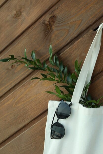 A variety of accessories made from sustainable materials, including a cork handbag, wooden sunglasses, a watch with a bamboo strap, and silver earrings made from recycled metal. The accessories are arranged on a minimalist white background, emphasizing their eco-friendly nature and stylish design.