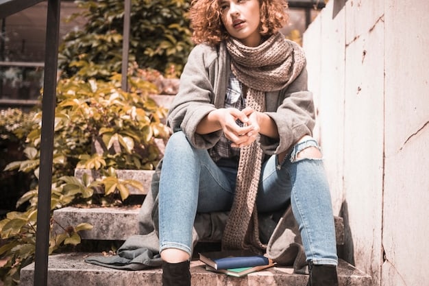 A person wearing a stylish outfit composed of thrifted clothing, including a vintage jacket, a patterned scarf, and upcycled jeans, photographed in a well-lit thrift store.