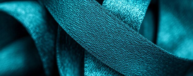 A close-up shot of various fabrics and textures dyed in deep teal, showcasing its depth and versatility.