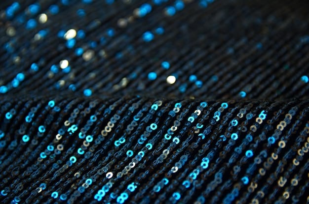 A close-up shot of a cobalt blue sequin dress with intricate patterns, highlighting the texture and detail of the sequins.