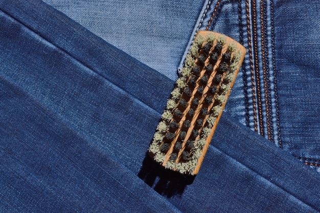 A close-up shot of various denim swatches showcasing a range of washes, including light acid wash, pastel pink, classic indigo, and ecru. The textures and subtle variations in color are highlighted, illustrating the diversity of denim washes for Spring 2025.