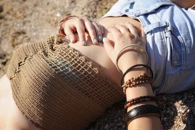 A detailed shot of a woman's hands adorned with multiple delicate layered necklaces and chunky chain bracelets, showcasing a mix of textures and styles in summer jewelry.