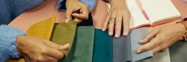 Close-up shot of a designer's hands carefully selecting and sorting through a variety of sustainable fabric samples, showcasing different textures and colors.
