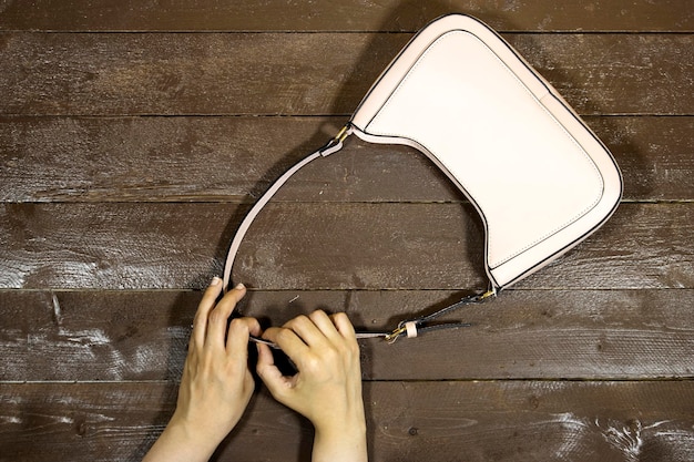 A close-up shot of a luxury handbag featuring a visible logo from a high-profile designer collaboration. The materials are high-quality, and the craftsmanship appears impeccable. The background is blurred, focusing attention on the product.