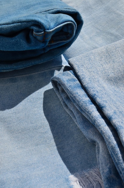 A detailed photograph showcasing swatches of various sustainable fabrics, including organic cotton, recycled denim, and innovative materials like Piñatex and Mylo. The image highlights the diverse textures and eco-friendly characteristics of these materials, emphasizing the designer's commitment to sustainable sourcing.