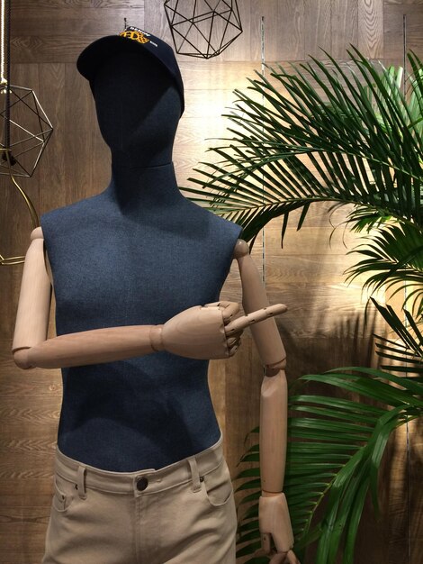 A mannequin wearing a stylish menswear outfit made entirely from recycled materials. The outfit should look fashionable and high-quality, demonstrating the potential of sustainable fabrics.