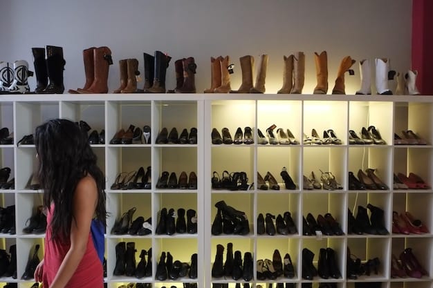 A brightly lit closet filled with various shoes organized neatly. There are rows of sneakers, boots, sandals, and dress shoes.