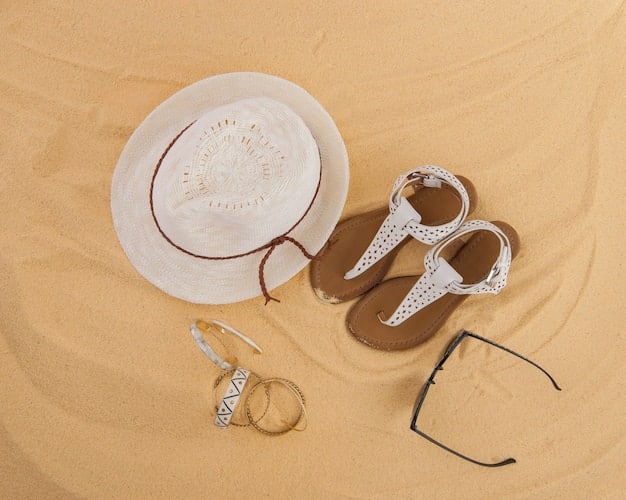 A detailed flat lay of various elegant swimwear accessories: a wide-brimmed straw hat, delicate gold anklet, stylish oversized sunglasses, and a woven beach bag, all arranged aesthetically.