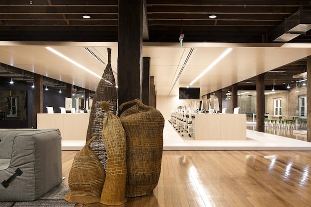 A minimalist, high-end design studio in downtown New York, showcasing sleek furniture and lighting, with a diverse group of designers collaborating on a mood board, emphasizing creativity and urban influence.