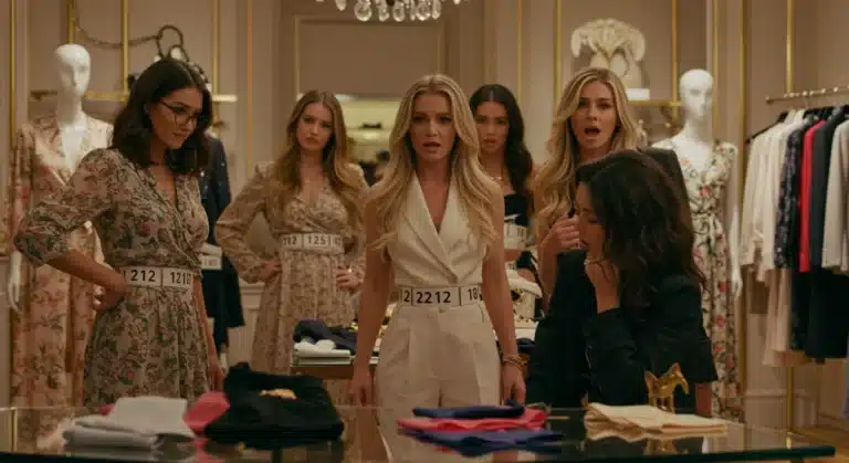 Women confused by inconsistent designer clothing sizes in a high-end boutique setting