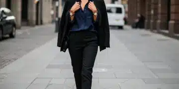 Woman in black blazer and navy blouse, elegant city style