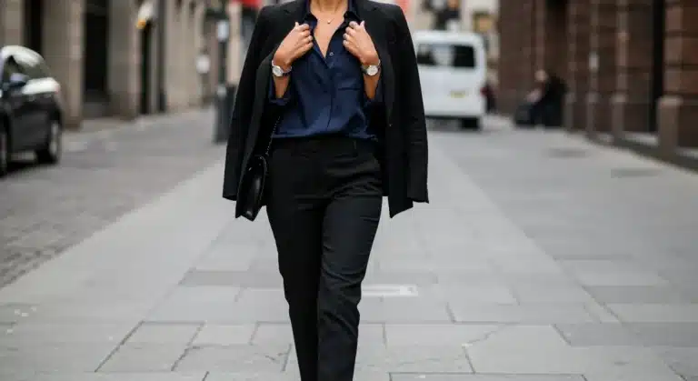 Woman in black blazer and navy blouse, elegant city style