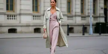 Woman in pastel trench coat and wide-leg trousers, embodying Spring 2026 integrated fashion.