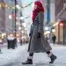 Stylish woman in winter ankle boots on snowy city street