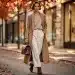 Woman in elegant Fall 2026 fashion, layered tailored coat and wide-leg trousers