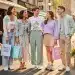 Stylish young adults wearing affordable spring 2026 fashion trends in a city park.