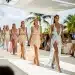 Models showcasing designs from a Resort 2026 collection on a sunlit runway.