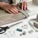 Hands sewing a hem on trousers with a sewing machine, transforming their look.